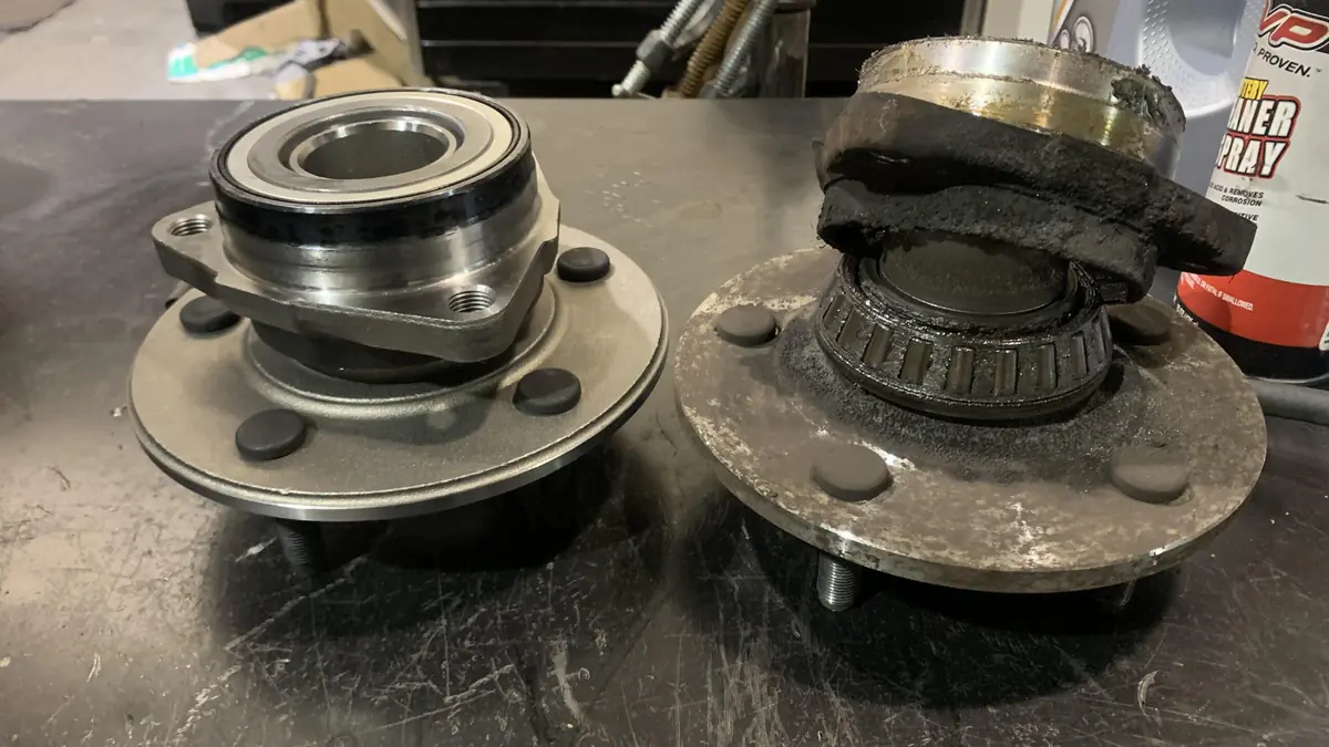 Worn wheel bearing next to a new one from a Dodge truck we diagnosed at our West Springfield shop
