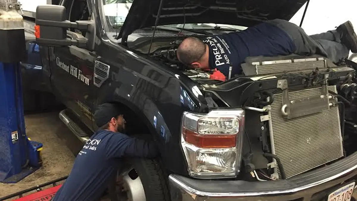 Technicians working on a Ford truck exhaust manifold at our West Springfield shop