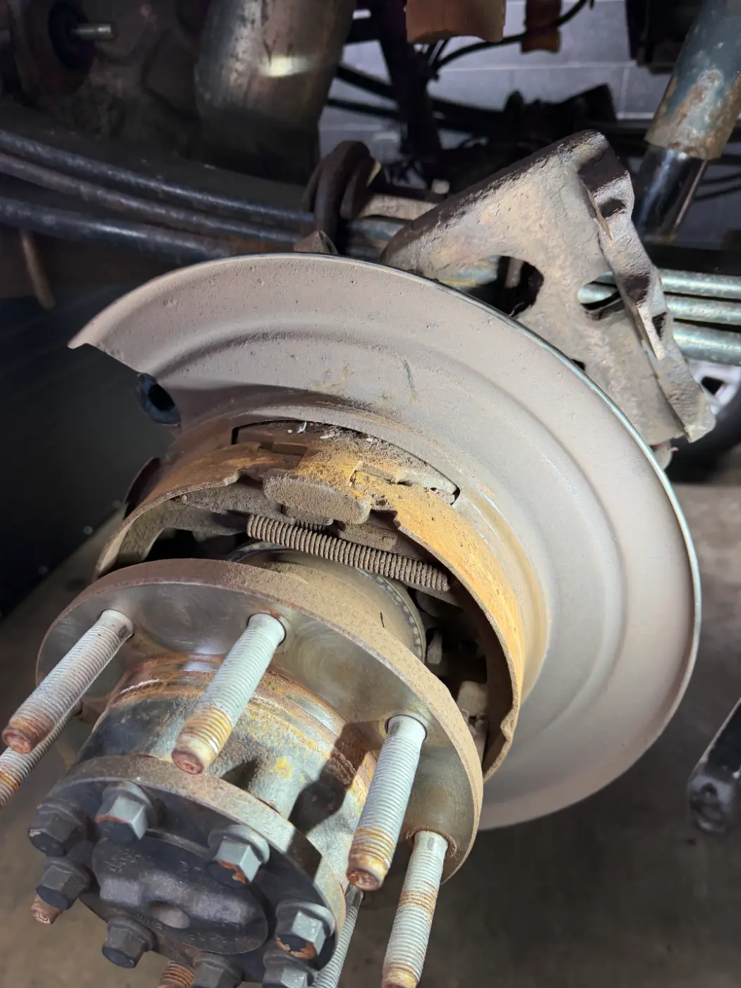 Rear brake on a Ford F250 that came in grinding, with rotted rotor and worn pads, at our South Windsor shop