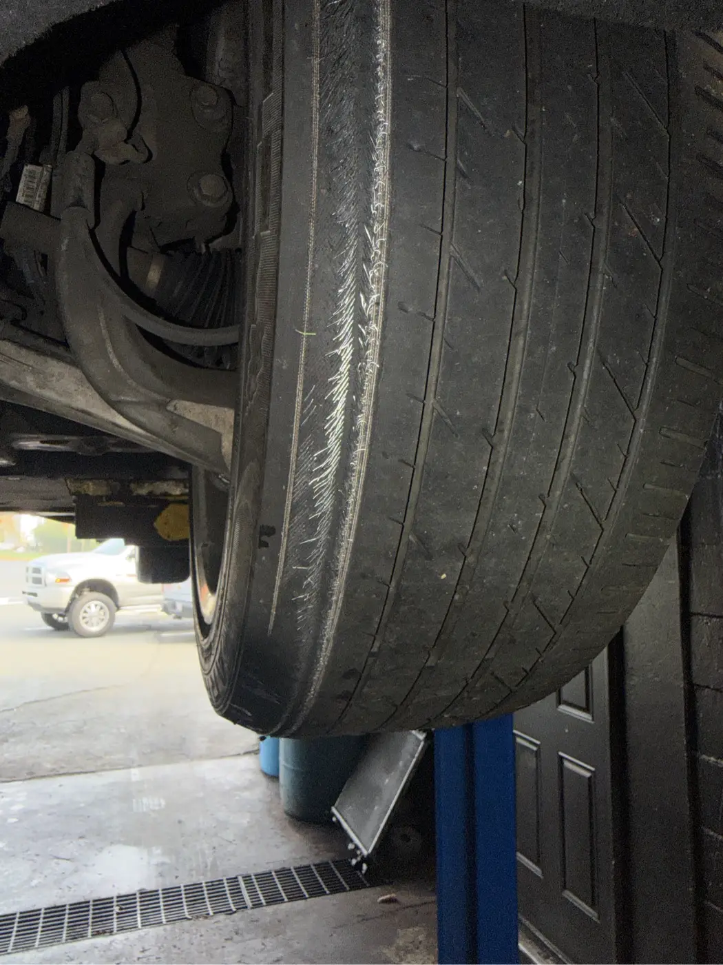 Cadillac tire worn on the inside edge with the steel belts showing, found during an oil change at our West Springfield shop