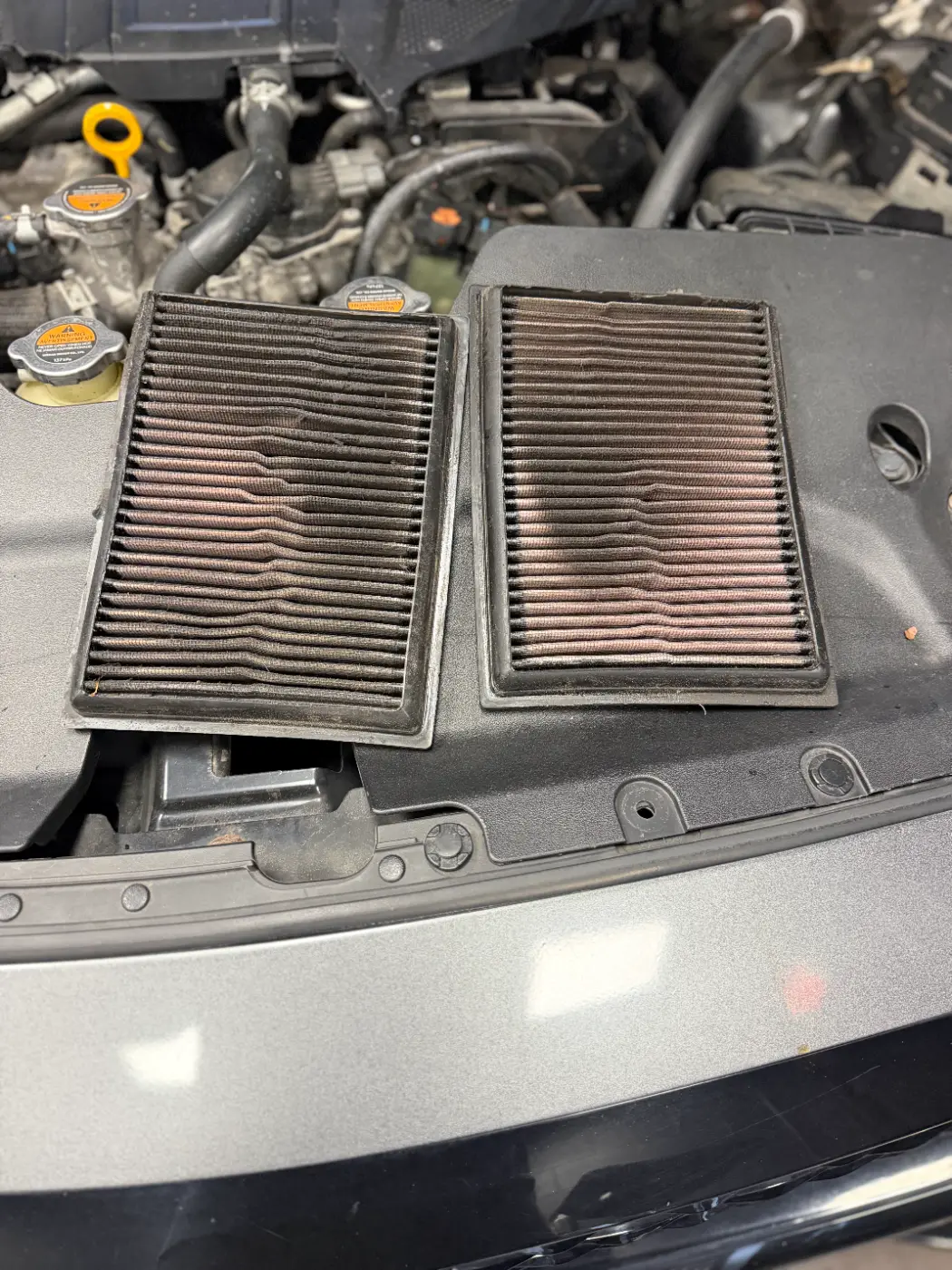 Two engine air filters pulled for inspection at our West Springfield shop