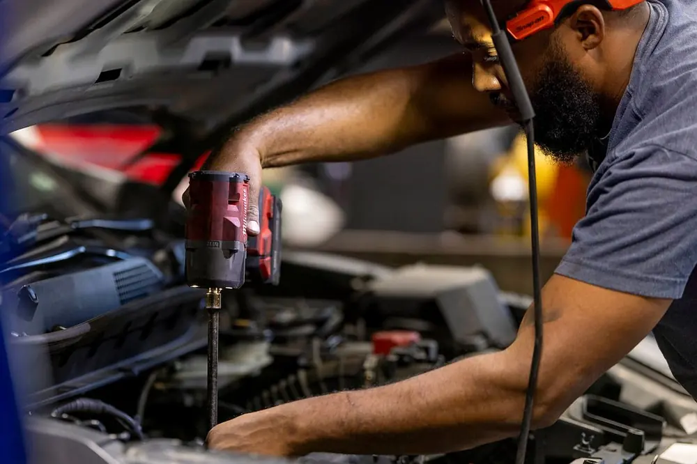 Precision Auto Repair technician working on a car