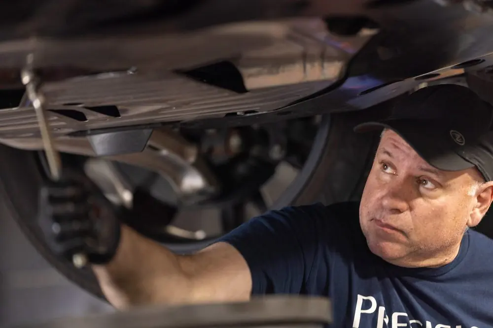 Precision Auto Repair technician working on a car