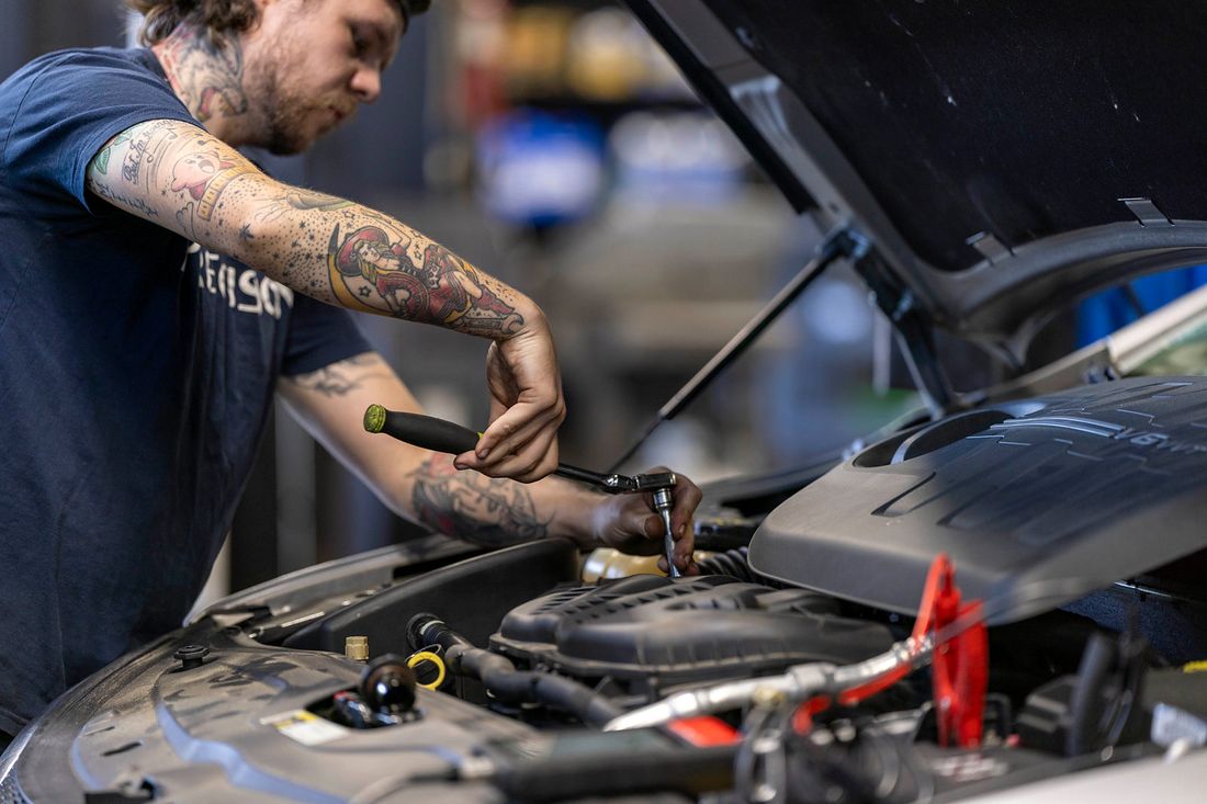 Precision technician working in an engine bay